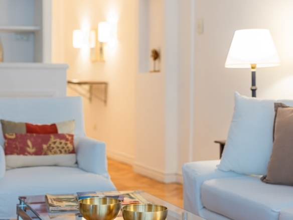 a living room filled with furniture and a glass table
