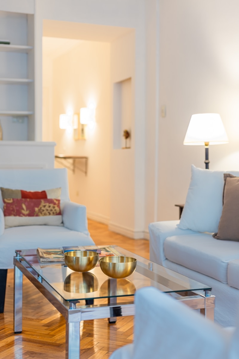 a living room filled with furniture and a glass table